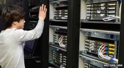 A man looking at a computer server