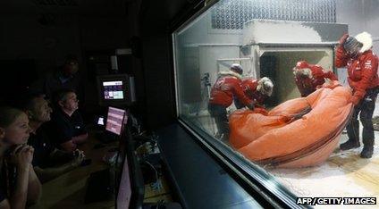 The team pack their tent down in the ice tank