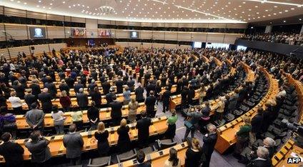 Members of the European Parliament standing in the hemicycle