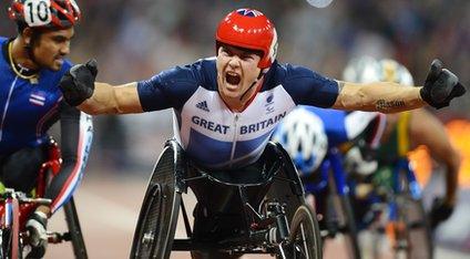 David Weir celebrates as he crosses the finish line