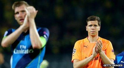 Arsenal players react at the final whistle after losing to Borussia Dortmund in the Champions League