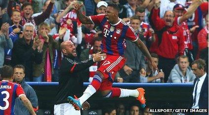 Jerome Boateng of Bayern Muenchen jumps for joy