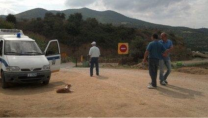 Police vehicle guarding the dig site