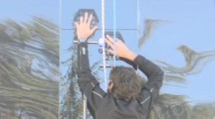 Man climbing up glass wall as part of Stanford University experiment.