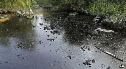 Oil from a Bangladeshi oil-tanker is seen on the Shela River in the Sundarbans in Mongla