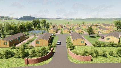 A CGI image of park homes - single storey wooden lodges in green space