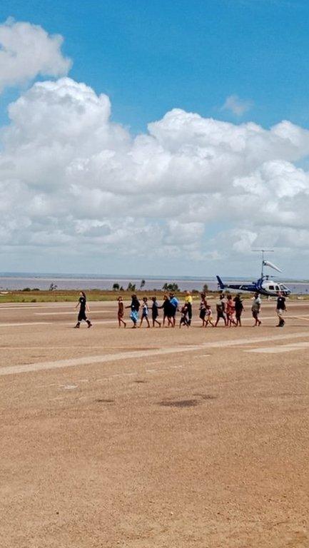 A group of people being evacuated from Fitzroy Crossing Airport
