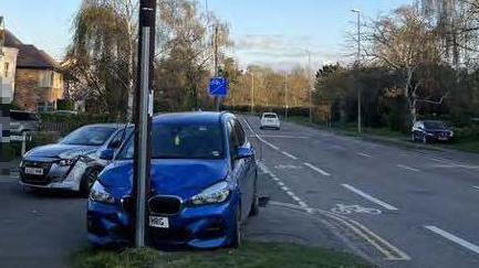 BMW with bonnet in telegraph pole, with damaged Peugeot behind it in Great Shelford