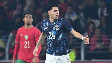 Paraguay's Gustavo Caballero with his thumb up and wearing a blue jersey with the number 24 on it celebrating his goal against Morocco