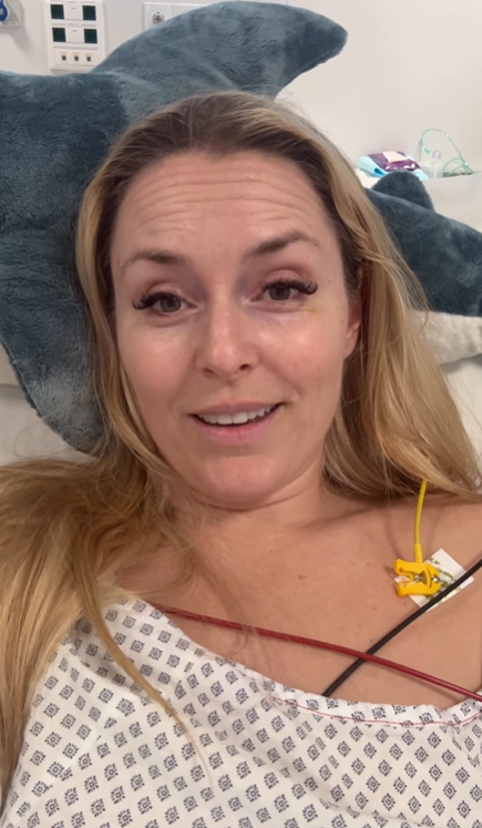 Lindsey Vonn, wearing a hospital gown, smiles