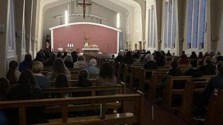 Shows people attending the Church of the Immaculate Conception in Maigh Cuilinn