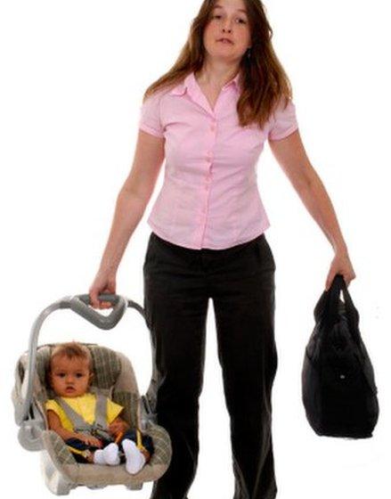 Woman carrying baby in car seat