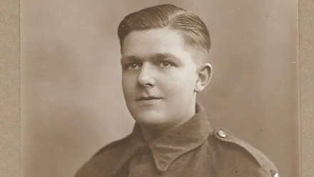 Young man in army uniform smiling