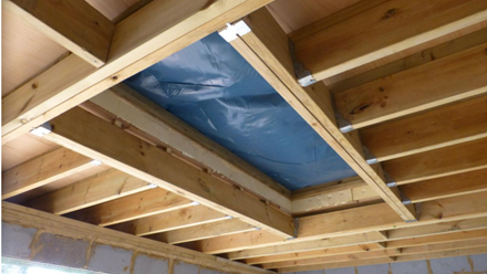 A hole in the ceiling covered by blue tarpaulin.