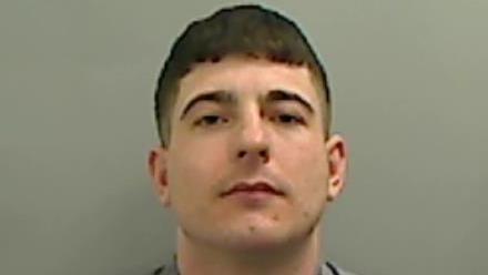 Mugshot of Macauley Wright. He is clean shaven with a pale face and short dark hair