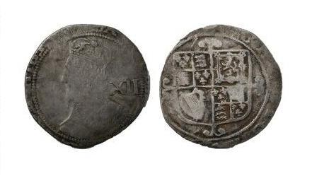 A worn silver coin. The left image shows a faded image of Charles I on the coin. Details of his crown can be made out. The left image shows the reverse side of the coin and shows a coat of arms, which include a harp and a lion. The coat of arms is off-centre.