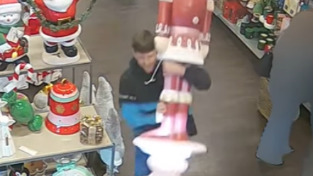A CCTV still of a man stealing a giant Christmas nutcracker