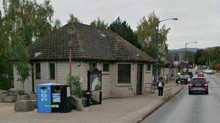 The toilets are on a side of Grampian Road in Aviemore. It is a block-type building with a peaked roof. 
