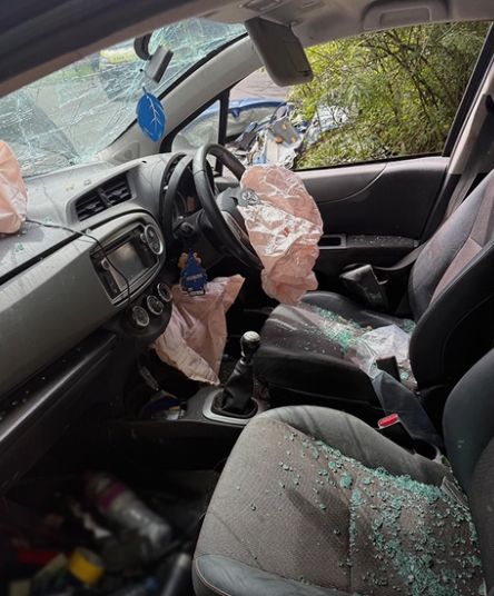 Inside of a car after a collision with glass on the seat and airbags