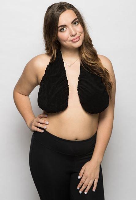 A woman poses in a black Ta-Ta Towel and black leggings