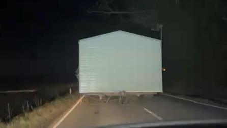 A white static caravan on the road 