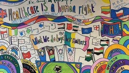 A colourful poster that reads 'Healthcare is a human right'. There are flags of different countries and a cartoon drawing  of four people holding a banner that reads 'what we do together matters' 