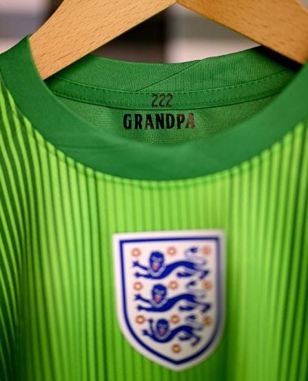 A green England goalkeeper shirt with 'Grandpa' printed on the inside of the collar