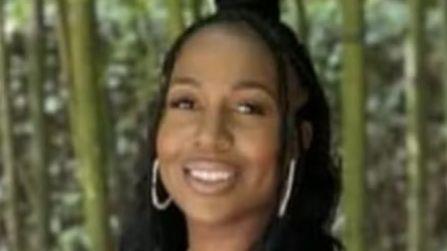 Michelle Sadio, a woman with long dark hair, smiling at the camera.