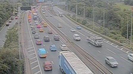Traffic is queuing in the clockwise carriageway at junction 11 of the M60.
