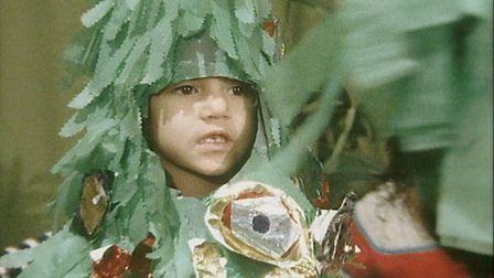 Child dressed as a Christmas tree