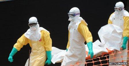 Medics remove body of a victim of the Ebola virus