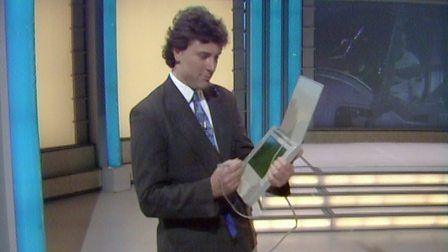 Howard Stableford holding the eletronic notepad with one arm and the attached stylus in the other hand