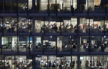 General view of office workers working late into the night