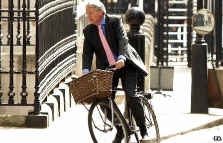 Andrew Mitchell riding a bicycle