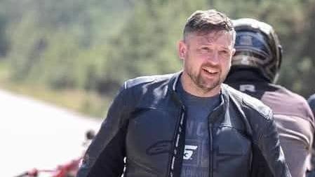 Mike Shepherd wearing a biker jacket and staring off the camera