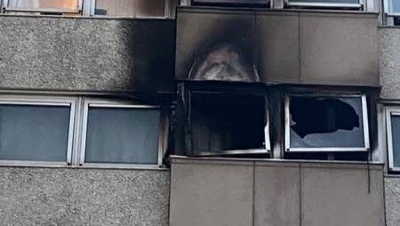 Fire-damaged windows and charred brickwork show the exterior of a flat after a blaze broke out on the fourth flour of the 12-storey tower.