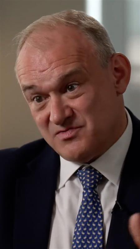 A man in a white shirt with a blue and white tie