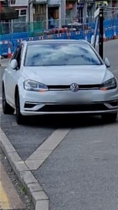 A car parked on a pavement.