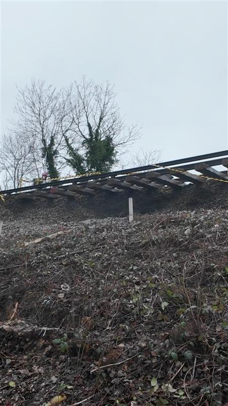 A view of the track dangling, where no land is supported it after a landslip.