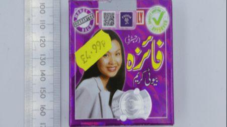 A price tag on a product, with a woman's face on it, with writing in a foreign language. It has a £4.99 yellow price sticker on it. There is also a ruler to the side to show the size to the product. 
