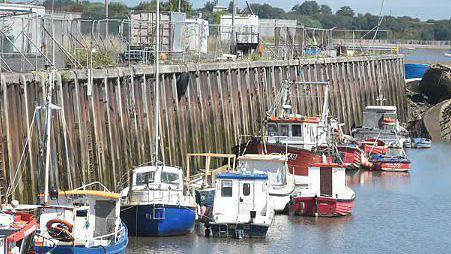 Fishing boats in Jubilee Quay, Fleetwood, on a sunny day.