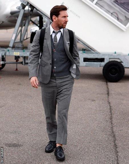 Lionel Messi and Barcelona players in expensive grey suits