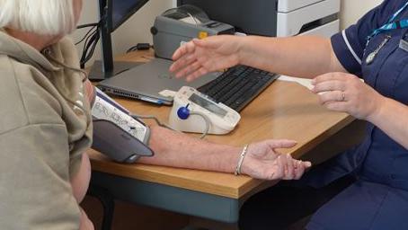 A woman having her blood pressure checked