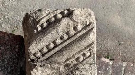 A close-up of decorated stone: diagonal lines in different widths, one made to look like beading