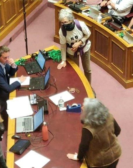 the two women with their hands on the desk