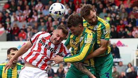 West Bromwich Albion defenders Chris Mepham (centre) and Nat Phillips (right) challenge for an aerial ball with Stoke City's Ben Wilmot (left)