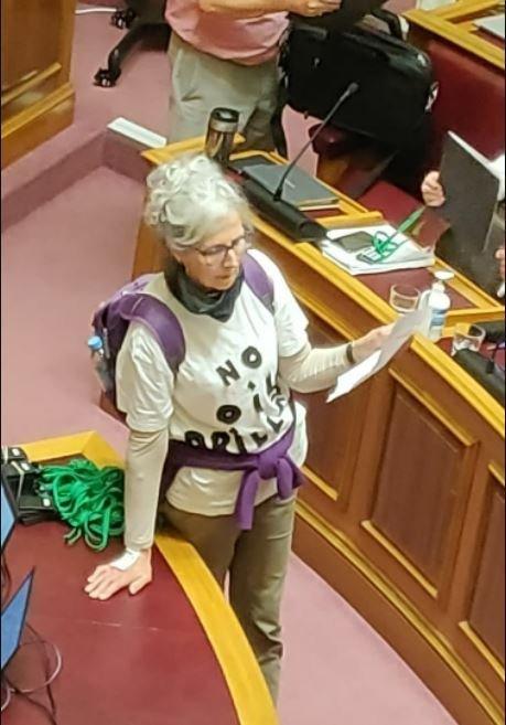 One of the two women with her hand on the desk