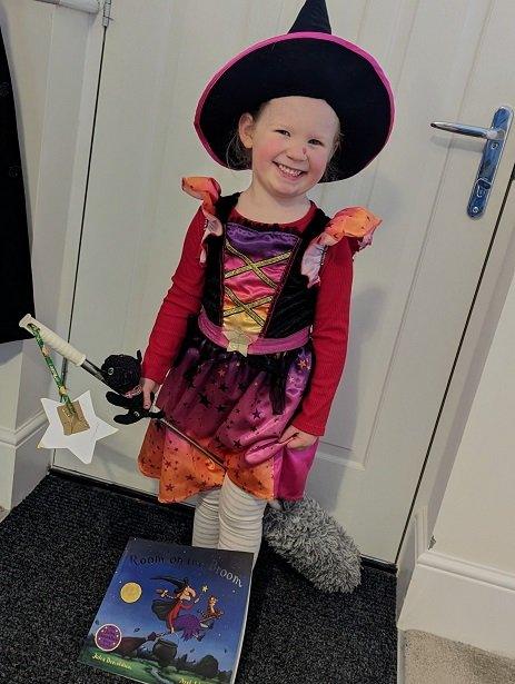 child dressed as room on broom witch