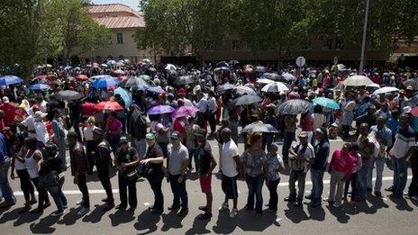 People queue up to get on buses to be taken to Union Buildings