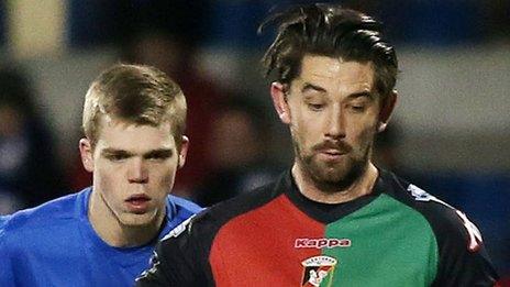 Phys Marshall of Glenavon in action against Glentoran striker Curtis Allen